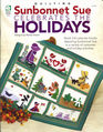 Sunbonnet Sue Celebrates the Holdiays Stitch 3D Calendar Blocks Depicting Sunbonnet Sue in a Variety of Costumes and Holiday Activities